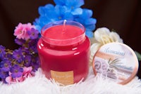 a jar with a candle and a candle next to it