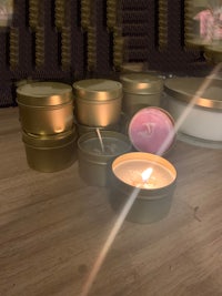 candles in tins on a wooden table