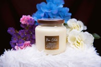 a jar of a candle with flowers on it