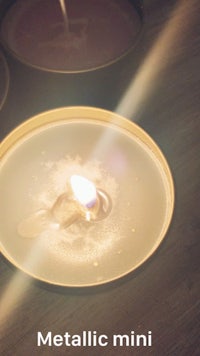 a candle with the words metallic mini on it