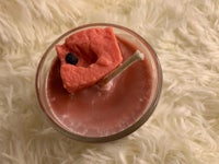 a watermelon in a glass with a straw